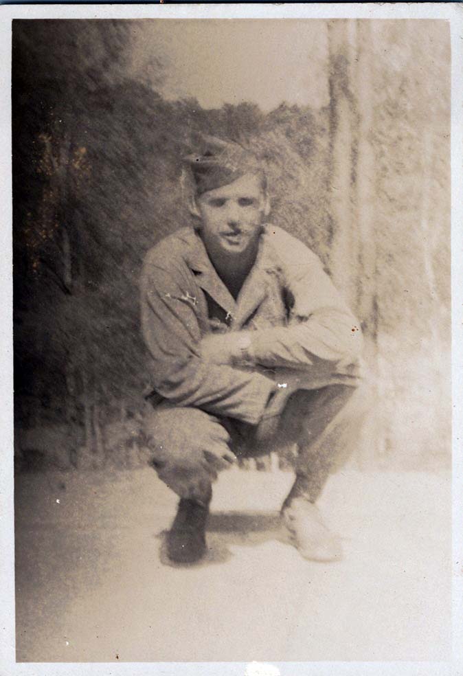 WW2 Photo of Soldier Crouching At Forest Edge